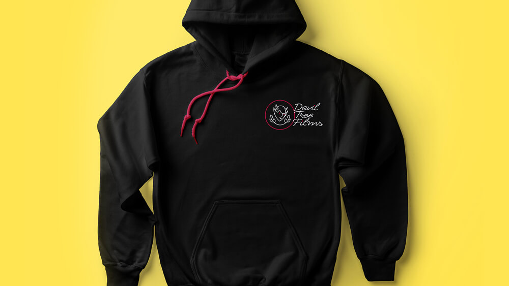 A black hooded sweatshirt with the Devil Tree Films logo on the pocket area.